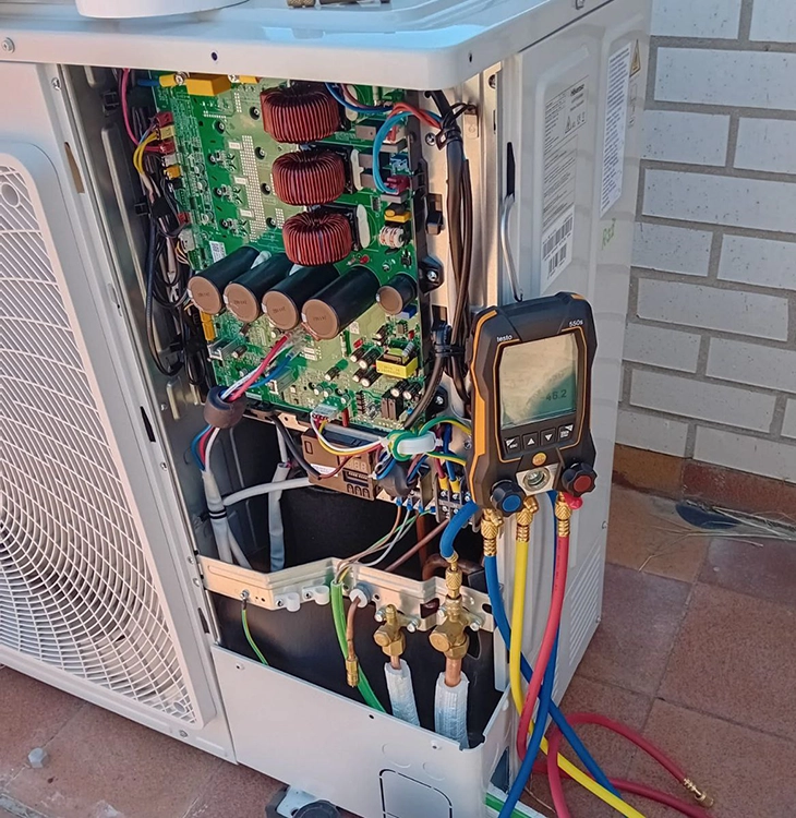 Técnico realizando mantenimiento de unidad exterior de aire acondicionado split en Valladolid, revisión y limpieza profesional del sistema
